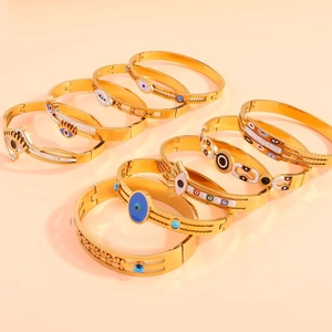 Collection of golden evil eye bracelets with blue enamel and sparkling rhinestones