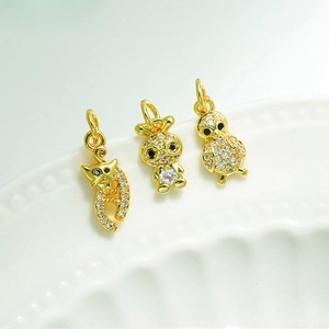 Detail of 18K gold plated animal pendants with cat, rabbit and chicken crystal charms