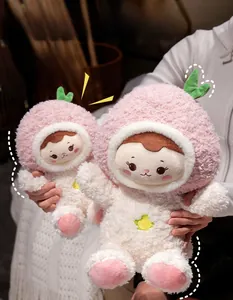 Detail showing two sizes of plush peach girl dolls with pink fur and star accents