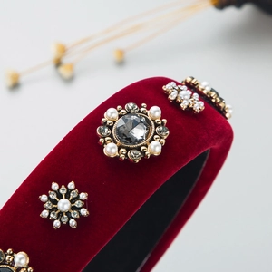 Macro shot of luxury burgundy velvet headband with baroque pearls and diamond flower crystals
