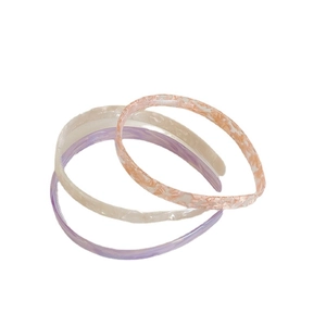Three-piece set of minimalist acetate headbands in pink floral, cream white, and lilac purple