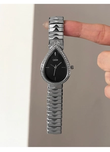 Detailed view of silver water drop watch dial with black face and sparkling rhinestones