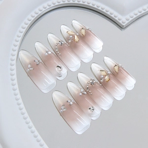 Cat eye stiletto press-on nails with ombre pearls and crystal diamonds on heart mirror