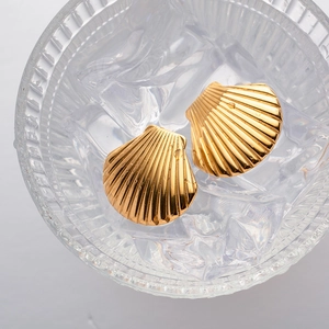 18K gold plated stainless steel shell earrings presented in a glass with ice cubes