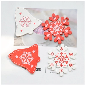 Detailed view of red and white wooden Christmas ornaments with snowflake patterns