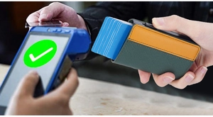Detail showing contrast color RFID wallet used for contactless payment at a POS terminal