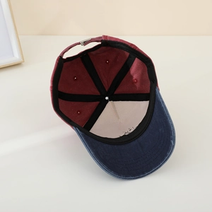 Detail of kids baseball cap interior showing blue brim, red crown and metal buckle