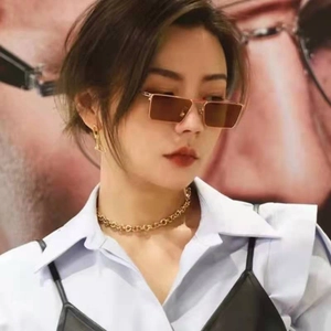 Minimalist square metal sunglasses with gold frame and brown gradient lenses on model