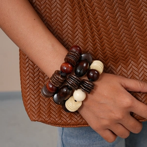 Detail of multi-layered vintage wooden bead bracelet with geometric coconut shell charms