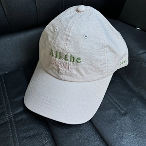 Detailed view of 'All the best' embroidery on a lightweight cotton gauze baseball cap