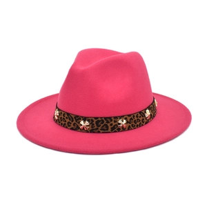 Close-up of rose red fedora with leopard print band and golden star rivets detail