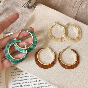 Three pairs of C-shaped marble resin hoop earrings in green beige and brown colors