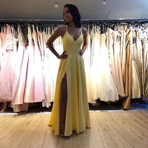 Elegant bright yellow V-neck evening gown with side slit and spaghetti straps