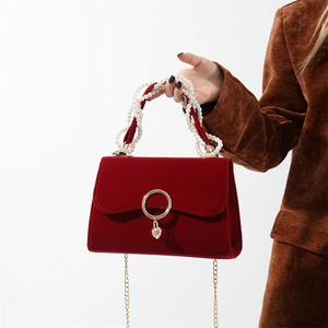 Elegant red velvet handbag with pearl handle and gold heart charm for wedding style