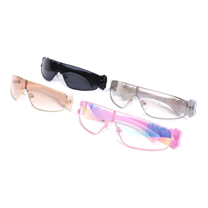 Detail of Y2K shield sunglasses featuring flower charms and colorful mirrored lenses
