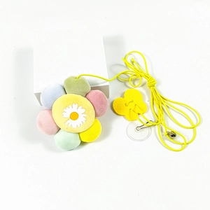 Detail of colorful plush sunflower cat toy with hanging rope and metal bell on white base