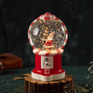 Christmas snow globe featuring Santa Claus in a red gashapon-style base with liquid glitter