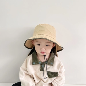 Detail of baby sun hat with neck flap and matching cotton sweatshirt with green trim