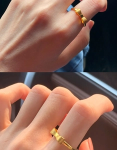 Detail of the golden bow-shaped ring featuring a delicate brushed texture finish
