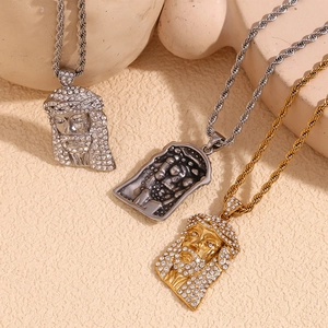 Detailed view of three Jesus head pendants with crystal inlays on twisted rope chains
