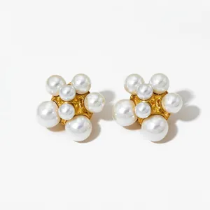 Macro shot of pearl flower cluster earrings with elegant gold metallic base details