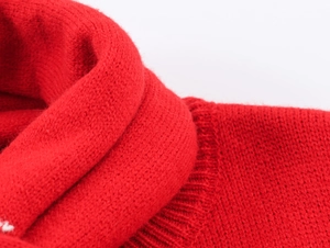 Detailed macro shot of thick red knitted fabric texture with warm winter fiber structure
