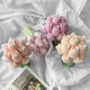 Macro detail of tulip-shaped candles with layered petals and green stem details