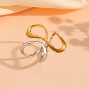 Detail of twisted mixed-metal ring featuring elegant gold and silver polished finishes
