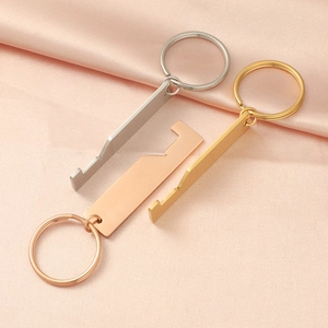 Detailed view of polished house-shaped stainless steel keychains in silver, gold, and rose gold