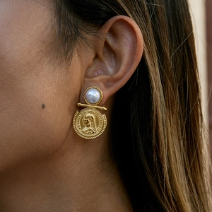 Macro shot of gold coin earring with pearl stud featuring Queen Victoria profile detail