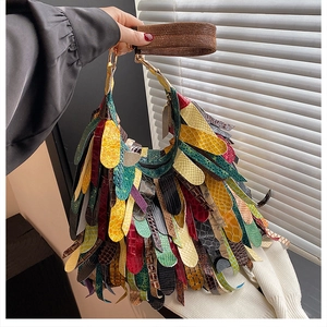 Detailed view of colorful patchwork leather strips and fringed Indian style fringe texture