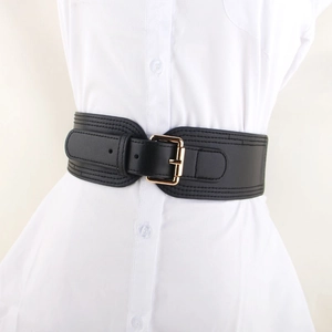 Elastic black wide waist belt with gold buckle on a white shirt dress for women