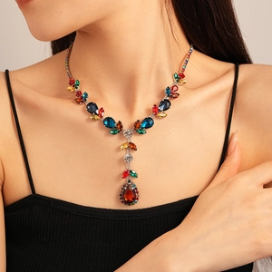 Close-up of luxury Y-shaped necklace with colorful crystals and fringe drops on model
