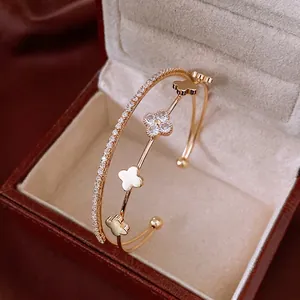 Zircon clover open bangle in gold finish featuring a double-layer minimalist design