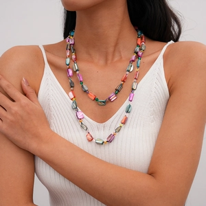 Detail of multi-colored shell and crystal beaded long necklace with layered styling