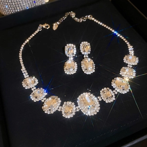 Close-up of luxury oval diamond choker and earrings set in a premium black gift box