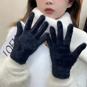 Close-up of black faux fur winter gloves showing plush texture and five-finger design