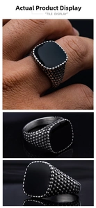 Detailed macro view of vintage punk steel ring with black rectangle stone and dots