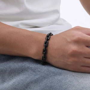 Close-up of men's black stainless steel chain bracelet worn on a wrist for a hip-hop style