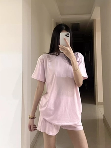 Pink minimalist short sleeve t-shirt and shorts lounge set shown in a mirror selfie