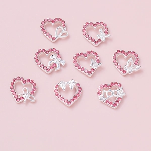 8-piece set of heart-shaped nail charms with pink rhinestones and hollow bow designs