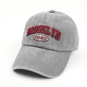 Detail of Brooklyn 1947 3D red embroidery on washed grey vintage baseball cap texture