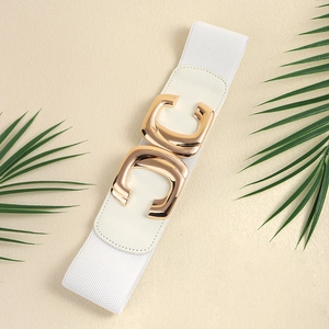 Detailed close-up of white elastic wide belt featuring a gold geometric double C buckle