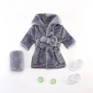 Gray flannel baby bathrobe set with towel, white slippers and cucumber props on white background