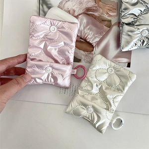 Detailed view of heart quilted AirPods cases with puffy fabric and circular clip