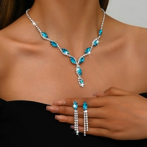 Close-up of luxury marquise blue crystal necklace and teardrop earrings on model