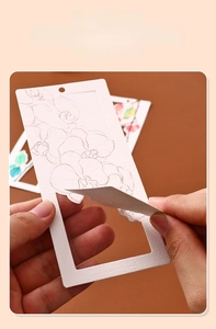 Detail of hand-held hollow-out white bookmark featuring an intricate orchid flower carving