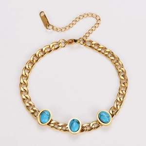 Detail of gold curb chain bracelet with oval green turquoise inlay and lobster clasp