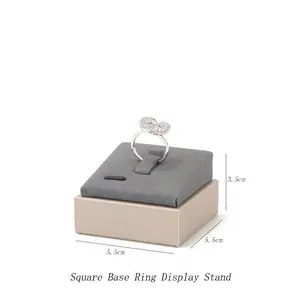 Grey velvet square ring display stand with gold frame and dimensions showing 5.5cm x 3.5cm