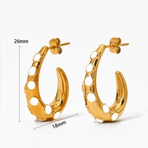 Detail of 26mm gold C-shape octopus tentacle earrings with white enamel dots